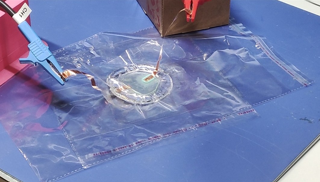 Two-channel high-voltage signal source during testing on a sample